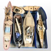 A group of remote control scale model boat hulls,