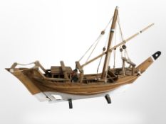 A wooden model ship, length 84cm.