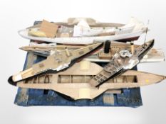 A group of remote control scale model boat hulls,