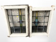 Two Victorian stained and leaded glass windows in painted surrounds, 66cm x 45cm overall.