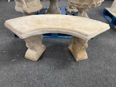 A concrete curved garden bench on squirrel supports, width 103cm.