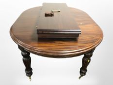 A Barker & Stonehouse Victorian style carved hardwood extending oval dining table with two leaves