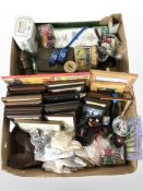 A group of vintage tins, framed cat prints, drinking glasses, plated cruet, lacework items, etc.