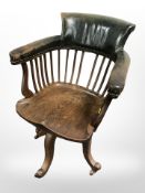 An Edwardian oak swivel office chair, width 59cm.