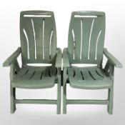 A pair of folding plastic garden armchairs.