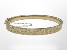 A 9ct gold engraved bangle, inner width 6cm.