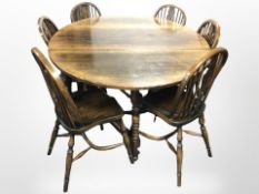 A good quality reproduction oak drop leaf gate leg dining table, extended 183cm.