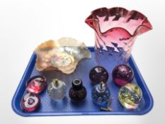 A group of glass paperweights including Caithness, a ruby glass light shade,