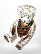 A Royal Crown Derby seated teddy bear paperweight with silver stopper,
