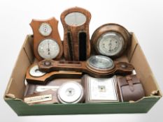 A group of oak barometers, pair of brushes on mirrored oak wall rack,