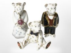 A Royal Crown Derby bride and groom pair of teddy bears, plus another seated teddy bear paperweight,