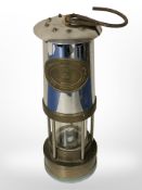 An E Thomas & Williams brass and chrome miner's lamp.