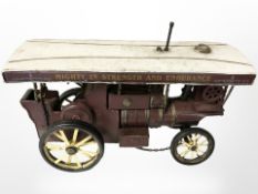 A tin plate model of a steam wagon, length 31cm.