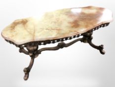 A cast brass and onyx top coffee table, 122cm long.