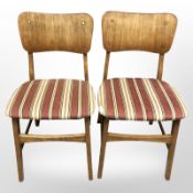 A pair of Danish laminated wood dining chairs in striped fabric