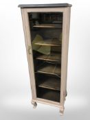 A painted pine glazed single door cabinet,