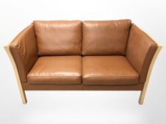 A late 20th century Danish Stouby stitched tan leather wooden framed two seater settee,