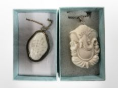 A Chinese mother of pearl pendant, carved with characters in gilt metal mount,