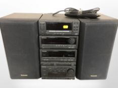 A Technics four piece hi-fi system with pair of speakers, lead and remote.