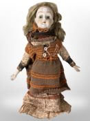 A bisque-headed doll,