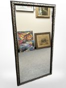 A contemporary mirror in a textured frame, 66cm x 124cm.