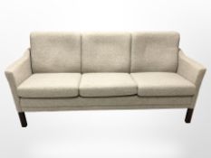 A late 20th century Danish three seater settee in oak meal coloured fabric,