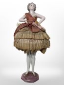 An Art Deco jointed porcelain doll, length 28cm.