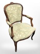 A continental carved beech salon armchair in floral upholstery