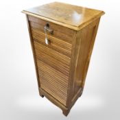 An early 20th century oak tambour front office pedestal filing cabinet, with key,