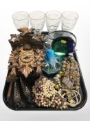 A reproduction carved cuckoo clock, a group of costume bead necklaces,