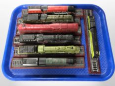 Seven scale model locomotives on plinths.
