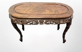 An oriental heavily carved hardwood oval occasional table,