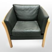 A late 20th century Danish dark green stitched leather wooden framed armchair,