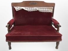 A 19th century mahogany hall settee in red dralon upholstery,