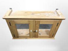 A glazed pine double door wall cabinet, width 93cm.