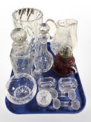 A group of glasswares including decanters with stoppers, vase, jug, cranberry glass, oil lamp,