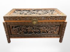 A 20th century oriental heavily carved camphor wood blanket chest,