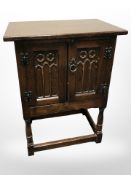 A reproduction oak double door low cabinet,