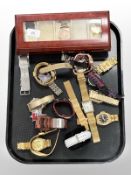 A group of gent's wristwatches and a watch display case.