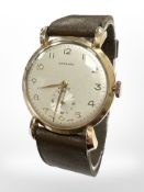 A 9ct yellow gold gentleman's wristwatch by Garrard & Co, in original retail box.