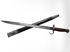 A British Military pattern 1907 sword bayonet with steel-mounted leather scabbard,