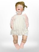 A German bisque-headed jointed doll, stamped '342 10 Germany', length 60cm.