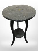 An early 20th century carved and ebonised beech occasional table,