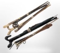 Four bundles of assorted walking sticks, some with polished horn handles, riding crops,