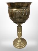 An early 20th-century brass planter on stand, height 63cm.