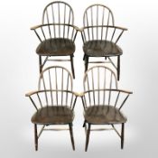 A set of four early-20th century beech spindle back elbow chairs.