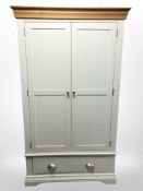 A modern oak and MDF painted double door wardrobe, 112cm x 58cm x 193cm.