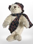 A Steiff winter bear, wearing tartan Tam O' Shanter and scarf.