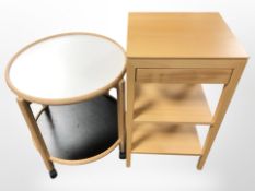 A modern Scandinavian single drawer side table and a circular trolley.