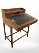 A mahogany fall-front clerk's writing desk with tooled leather interior,